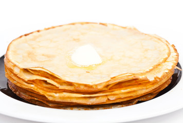 Crepes on white plate wit butter