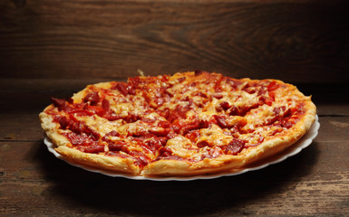 round pizza on wood background