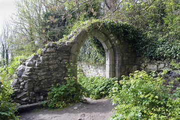 ruined arch in a lost place forest