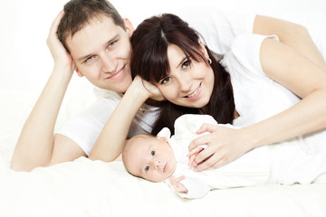 Happy family, parents embracing newborn baby