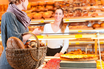 Salesperson with female customer in bakery