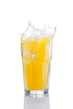 Splash In Glass Of Orange Soda With Ice Cubes
