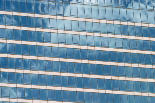Glass wall of modern office building facade closeup