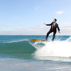 Young business person surfing on the waves