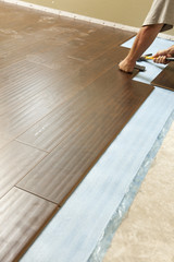 Man Installing New Laminate Wood Flooring