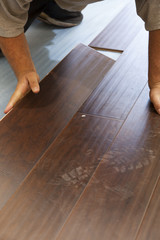 Obraz na płótnie Canvas Man Installing New Laminate Wood Flooring