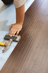 Man Installing New Laminate Wood Flooring