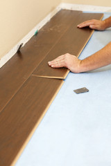 Man Installing New Laminate Wood Flooring