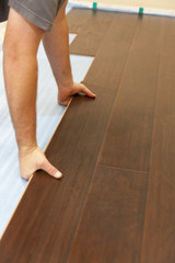 Man Installing New Laminate Wood Flooring