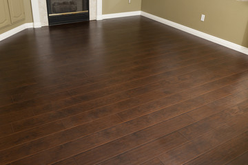 Newly Installed Brown Laminate Flooring and Baseboards in Home