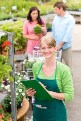 Smiling florist woman at garden centre inventory