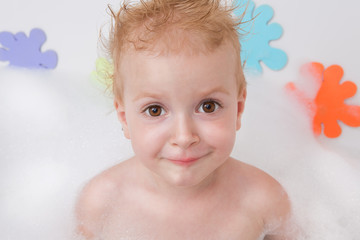 Baby in bath with soap suds