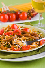 Spaghetti with squids, peas and cherry tomatoes.