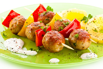 Grilled meat and vegetables on white background