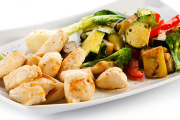 Grilled meat and vegetables on white background