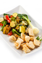 Grilled meat and vegetables on white background