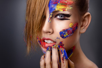 beautiful young girl with paint on his face