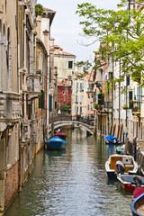 Fototapeta na wymiar Traditional Venetian buildings along a water channel, Venice
