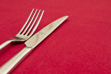 Knife and fork on red tablecloth