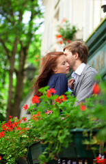 Man and woman together on balconyof their house or hotel with bl