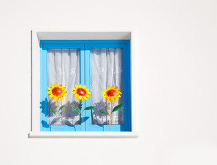 Balearic blue window with three sunflowers