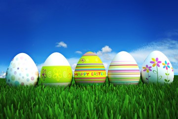 Happy Easter, colored eggs in a grass field