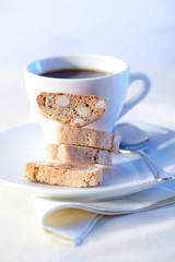 Cantucci cakes and cup of coffee on background