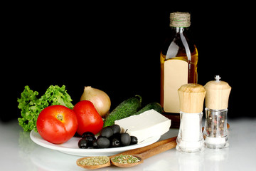 Ingredients for a Greek salad on black background