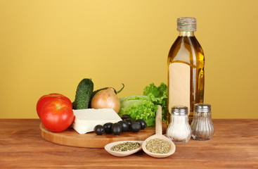 Ingredients for a Greek salad on brown background close-up