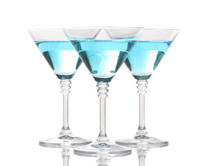 Blue cocktail in martini glasses isolated on white