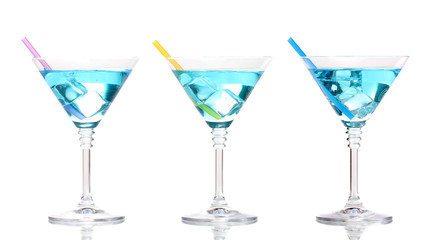 Blue cocktail in martini glasses isolated on white