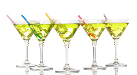 Yellow cocktail in martini glasses isolated on white