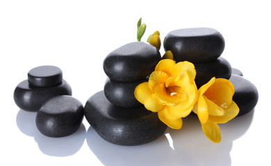Spa stones and yellow flower isolated on white