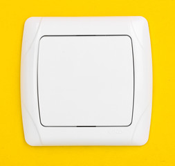 Modern light switch on yellow background