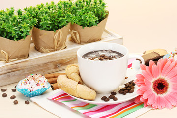 cup of coffee and gerbera  beans, cinnamon sticks
