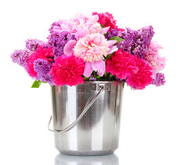 beautiful spring flowers in metal bucket isolated on white