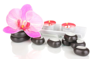 Fototapeta na wymiar Spa stones with orchid flower and candles isolated on white