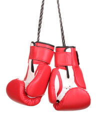 Red boxing gloves hanging isolated on white