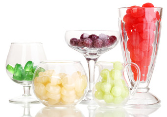 Color candies in glasses isolated on white
