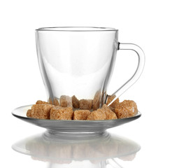 Lump brown cane sugar cubes in glass cup isolated on white