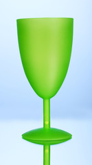 Bright plastic goblet on blue background