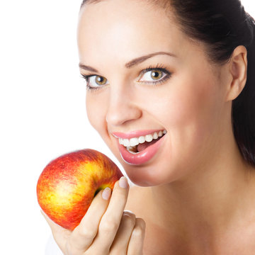 Young woman eating apple, isolated