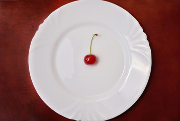 Single cherry on plate