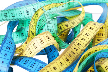 Yellow, green and dark blue measuring tapes 