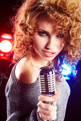 woman holding a retro microphone
