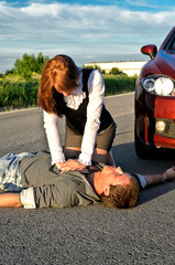 Young man reanimation on a road. Concept first aid
