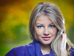 Close Up Portrait of Beautiful blonde girl posing in a  forest