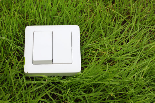 Light Switch On A Green Grass Background