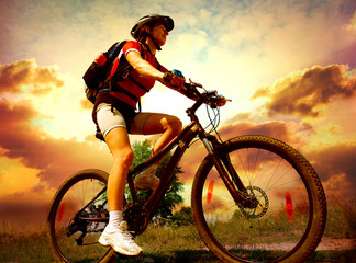 Happy Young Woman riding bicycle outside. Healthy Lifestyle