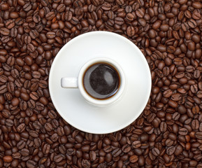 Cup with Hot Coffee on Coffee Beans